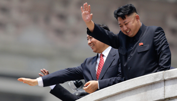 North Korean leader Kim Jong-un waves next to China's Vice President Li Yuanchao during a parade in Pyongyang (Reuters/Jason Lee)