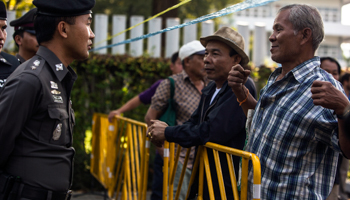 A protester gestures as he speaks with a policeman over a barrier to demand he be allowed to vote (Reuters/Nir Elias)