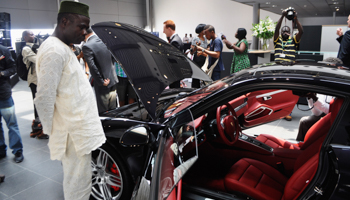 A Nigerian man looks at a vehicle by German carmaker Porsche in Lagos (Reuters/Monica Mark)