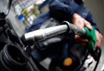 A customer fills his motorcycle at a petrol station in Nice, France (Reuters/Eric Gaillard)