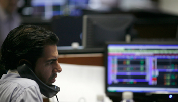 A broker talks on the phone as he monitors stock prices at Multiva Bank in Mexico City (Reuters/Carlos Jasso)