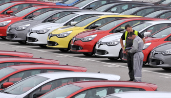 Renault cars produced in Turkey and awaiting export throughout Europe, are checked by workers in the port of Koper (Reuters/Srdjan Zivulovic)