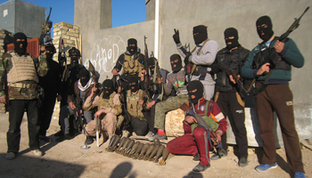 Masked Sunni Muslim gunmen pose for a photo during a patrol in the city of Falluja (Reuters/Stringer)