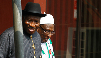 Nigeria's President Goodluck Jonathan leaves with Bamanga Tukur after a People's Democratic Party National Executive Council meeting (Reuters/Afolabi Sotunde)