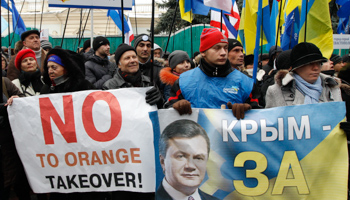 Supporters of Ukranian President President Viktor Yanukovich hold flags and placards during a rally in central Kiev December (Reuters/Vasily Fedosenko)