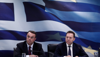 Finance Minister Yannis Stournaras and Deputy Finance Minister Christos Staikouras listen to questions during a news briefing in Athens (Reuters/Yorgos Karahalis)