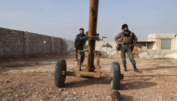 Fighters from Islamist Syrian rebel group Jabhat al-Nusra stand behind a mortar near Aleppo (Reuters/Mahmoud Hebbo)