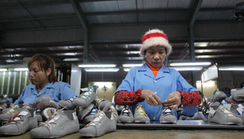 Employees work on an assembly line at a shoe factory outside Hanoi, Vietnam (Reuters/Kham)