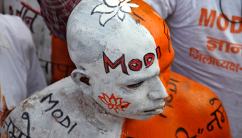 A supporter of India's main opposition Bharatiya Janata Party with his body painted attends a rally addressed by Hindu nationalist Narendra Modi (Reuters/Pawan Kumar)