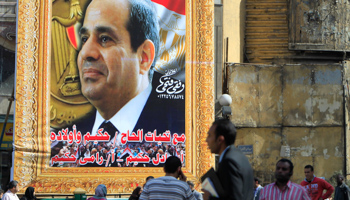 People walk past a banner for army chief Field Marshal Abdel Fattah El-Sissi in Cairo (Reuters/Mohamed Abd El Ghany)