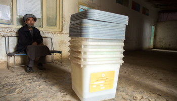 An Afghan man sits near ballot boxes (Reuters/Zohra Bensemra)