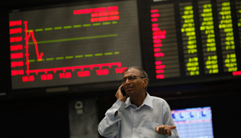 An investor reacts as he talks on a mobile phone at Karachi Stock Exchange (Reuters/Akhtar Soomro)