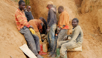 Artisanal gold miners sit outside a tunnel in the Democratic Republic of Congo (Reuters/Kenny Katombe)