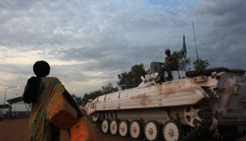 A woman passes an UN armoured vehicle inside the United Nations Mission in South Sudan (UNMISS) camp in Malakal (Reuters/Andreea Campeanu)