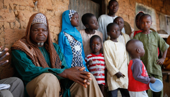 The leader of the Fulani herdsmen sits next to children (Reuters/Afolabi Sotunde)