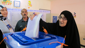 A woman casts her vote at a polling station during a parliamentary election in Baghdad (Reuters/Ahmed Malik)