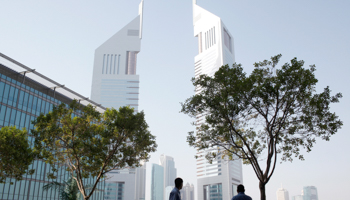 Men stand at the Dubai International Financial Center (Reuters/Ahmed Jadallah)