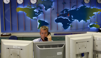 A trader works in the dealing room (Reuters/Baz Ratner)