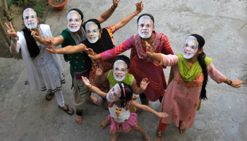 Supporters wearing masks of Hindu nationalist Narendra Modi (Reuters/Jitendra Prakash)