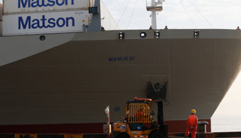 Workers in front of a cargo vessel at the port in Ningbo, China (Reuters/Stringer)