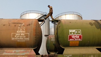 A worker walks atop a tanker wagon at an oil terminal in Kolkata (Reuters/Rupak De Chowdhuri)