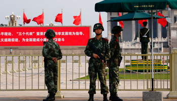 Paramilitary policemen stand guard at the Monument to the People's Heroes at Tiananmen Square (Reuters/Petar Kujundzic)