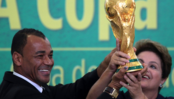 Former Brazilian soccer player Cafu and President Dilma Rousseff hold up the World Cup trophy (Reuters/Joedson Alves)
