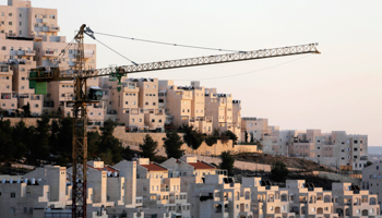 A crane is seen next to homes in a Jewish settlement near Jerusalem (Reuters/Ammar Awad)