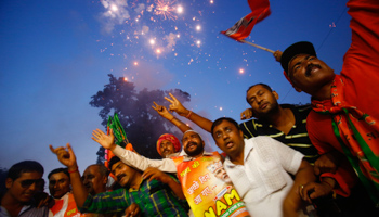 Supporters of Bharatiya Janata Party (BJP) celebrate after Narendra Modi was sworn in (Reuters/Anindito Mukherjee)