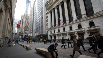 People walk by the New York Stock Exchange (Reuters/Brendan McDermid)