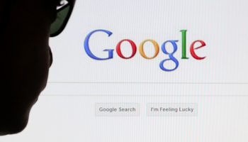 A computer user in front of a Google search page (Reuters/Francois Lenoir)