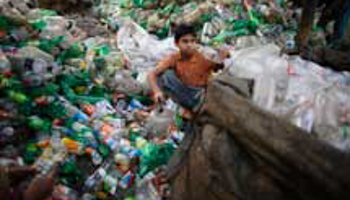 A boy works at a plastic bottle recycling centre in Dhaka (Reuters/Andrew Biraj)