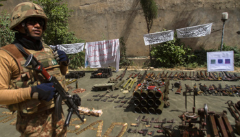 A Pakistani soldier stands by ammunition seized during a military operation against Taliban militants (Reuters/Maqsood Mehdi)