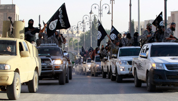 Militant Islamist fighters parade on military vehicles along the streets of northern Raqqa province (Reuters/Stringer)