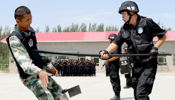 Policemen at an anti-terrorist drill in Xinjiang, China (Reuters/China Daily)