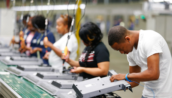 Workers on the assembly line replace the back covers of television sets at Element Electronics in Winnsboro, South Carolina (Reuters/Chris Keane)