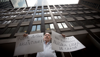 A protester outside the office of a court-appointed mediator in New York (Reuters/Andrew Kelly)