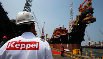 A worker passes a floating production, storage and offloading vessel modified and upgraded for Malaysia-based Bumi Armada (Reuters/Edgar Su)