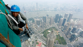 A labourer works atop the Shanghai Tower in Shanghai Reuters/Stringer)