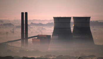 Early morning smog shrouds cooling towers of a power plant in Cape Town, South Africa (Reuters)