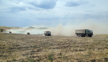 Military trucks travel through the steppe near the village of Krasnodarovka in Rostov region (Reuters/Maria Tsvetkova)