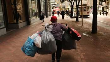 A woman carries sacks filled with discarded items in San Francisco (Reuters/Robert Galbraith)