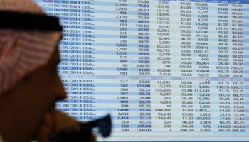 A man looks on as he sits next to a screen showing stock prices at the FALCOM investment bank in Riyadh August (Reuters/Faisal Al Nasser)