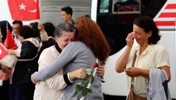 An employee at Turkey's consulate in Mosul is welcomed by her relatives at Esenboga airport in Ankara  (Reuters/Stringer)