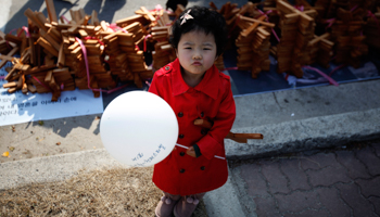 A girl stands in front of crosses before a procession to celebrate Easter at a church in Icheon (Reuters/Kim Hong-Ji)