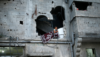 A girl looks out through her family's damaged house in Gaza City (Reuters/Mohammed Salem)