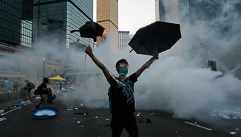 A protester raises umbrellas to ward off tear gas (Reuters/Tyrone Siu)