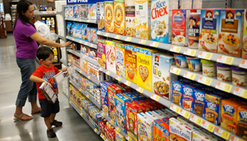 A woman and child shop at a Walmart to Go convenience store (Reuters/Rick Wilking)