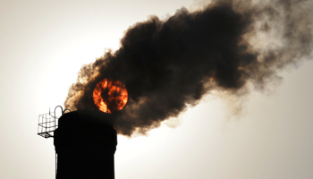 The sun is seen behind smoke billowing from a chimney of a heating plant in Taiyuan, Shanxi (Reuters/Stringer)