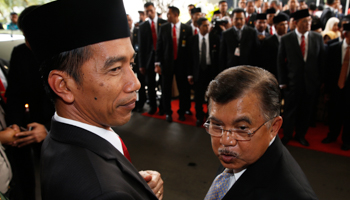 President-elect Joko Widodo stands with vice president-elect Yusuf Kalla after a ceremony inaugurating a new parliament in Jakarta (Reuters/Beawiharta)